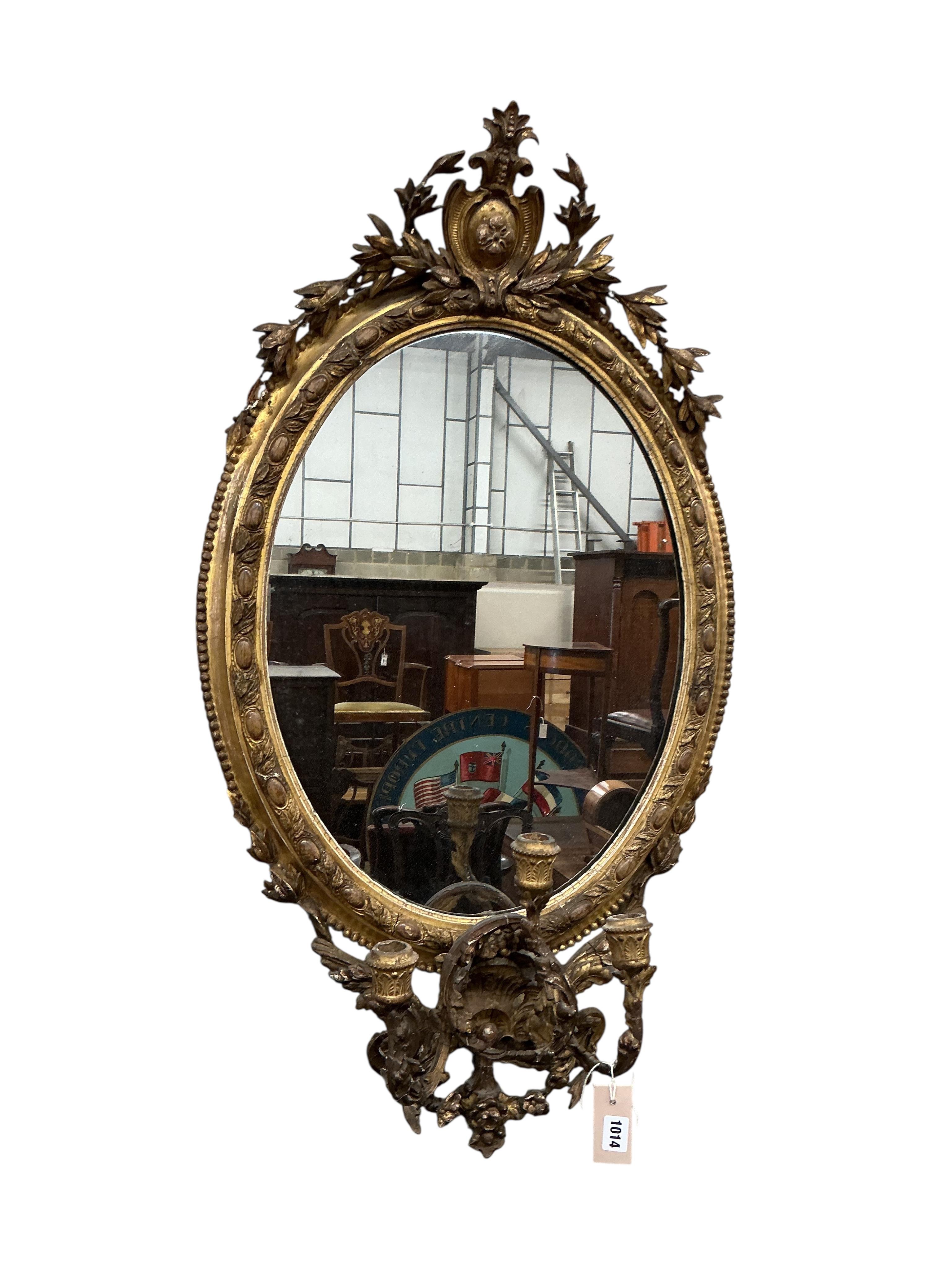 A Victorian oval giltwood and composition girandole wall mirror, width 56cm, height 100cm